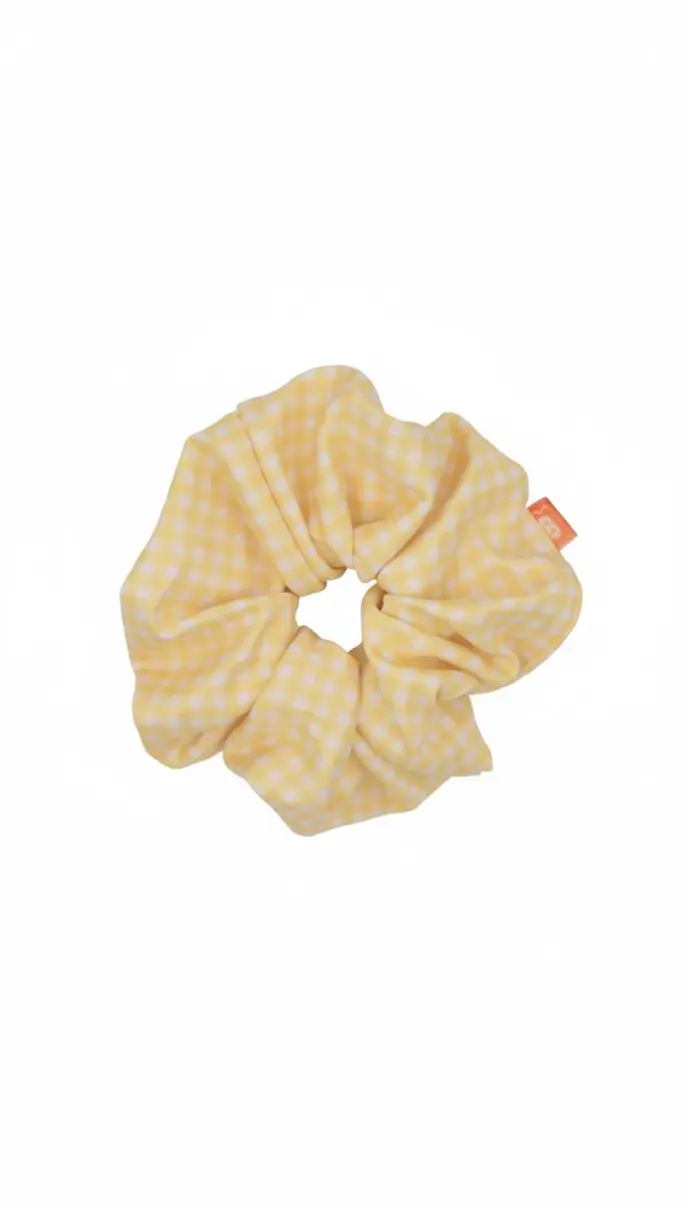 Fluffy scrunchie from Bikiboom’s Honey Mirage collection, featuring small white and pastel yellow gingham check patterns. Cute and stylish hair accessory perfect for summer outfits.